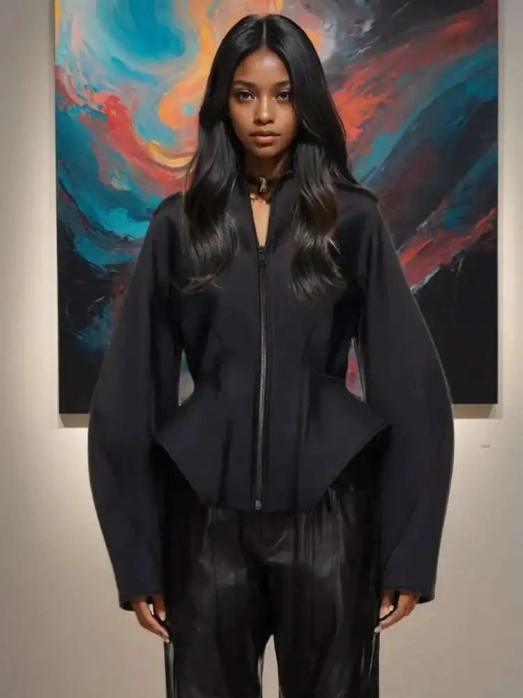 Person wearing a black outfit in front of a colorful abstract painting