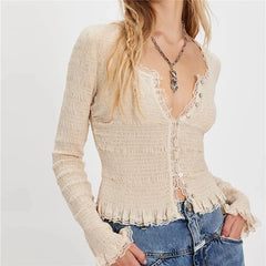 Beige lace-up top worn by a person on a plain background