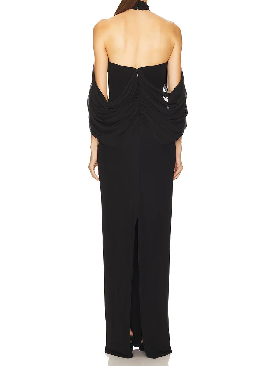 Black halter neck gown with open back on a white background