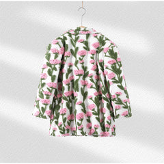 Floral patterned shirt on a hanger against a white background