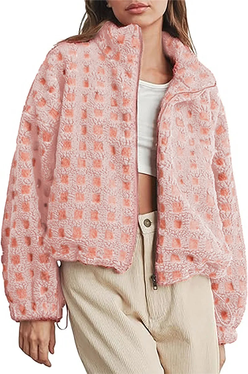 Person wearing a pink textured jacket with a white background