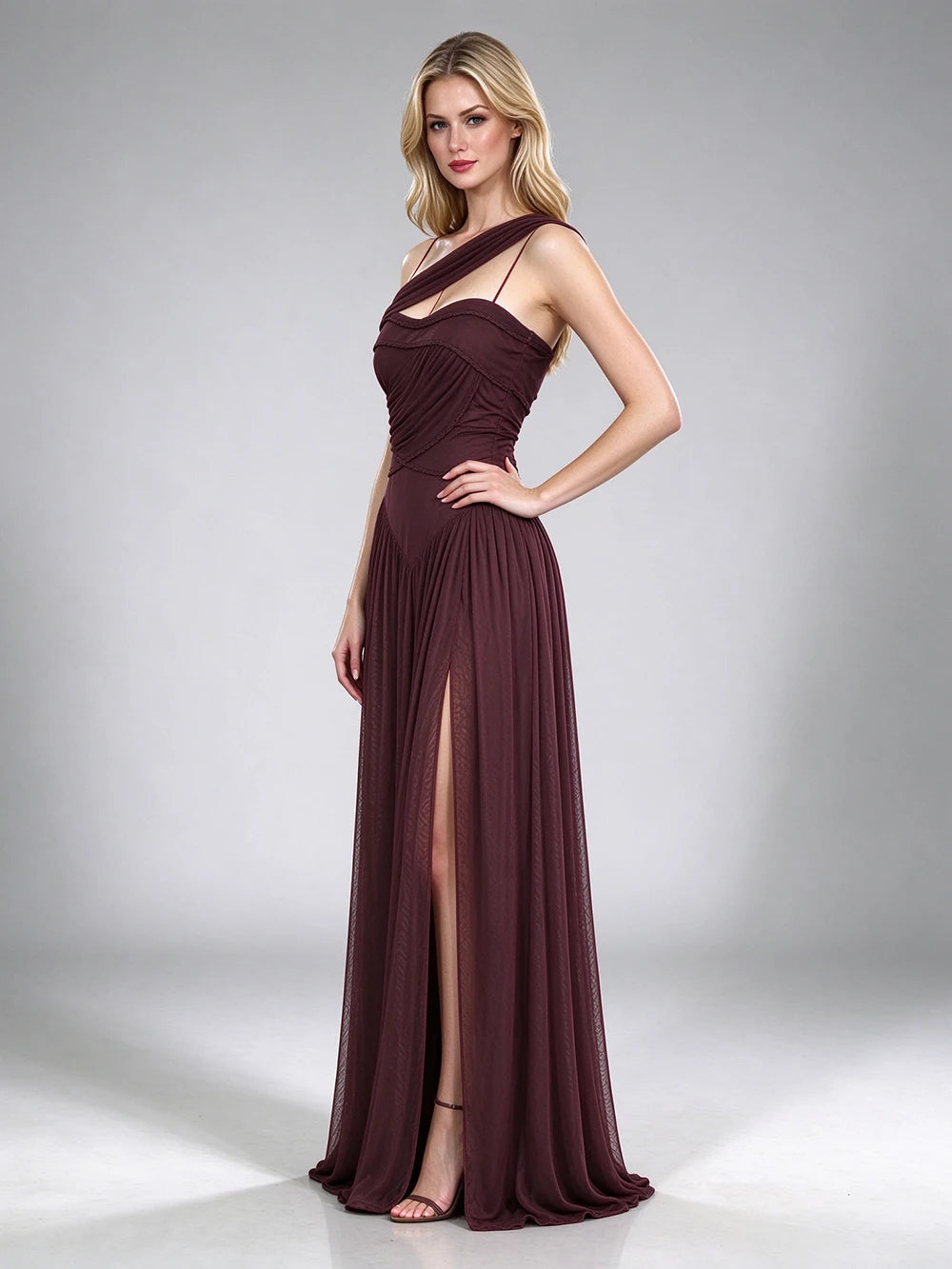 Full body shot of a brown one-shoulder draped formal gown with a high leg slit.