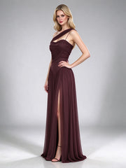 Full body shot of a brown one-shoulder draped formal gown with a high leg slit.