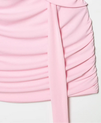 Pink dress with ruched design on a light gray background