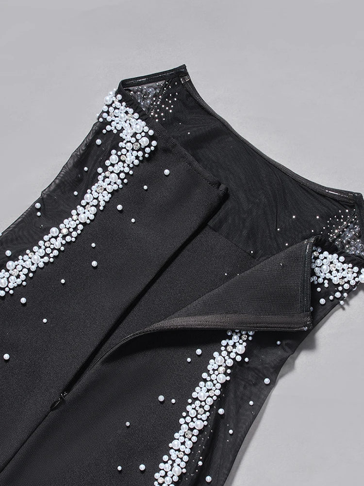 Black outfit with white embellishments on a gray background