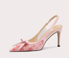 Pink high-heeled shoe with floral design on a white background