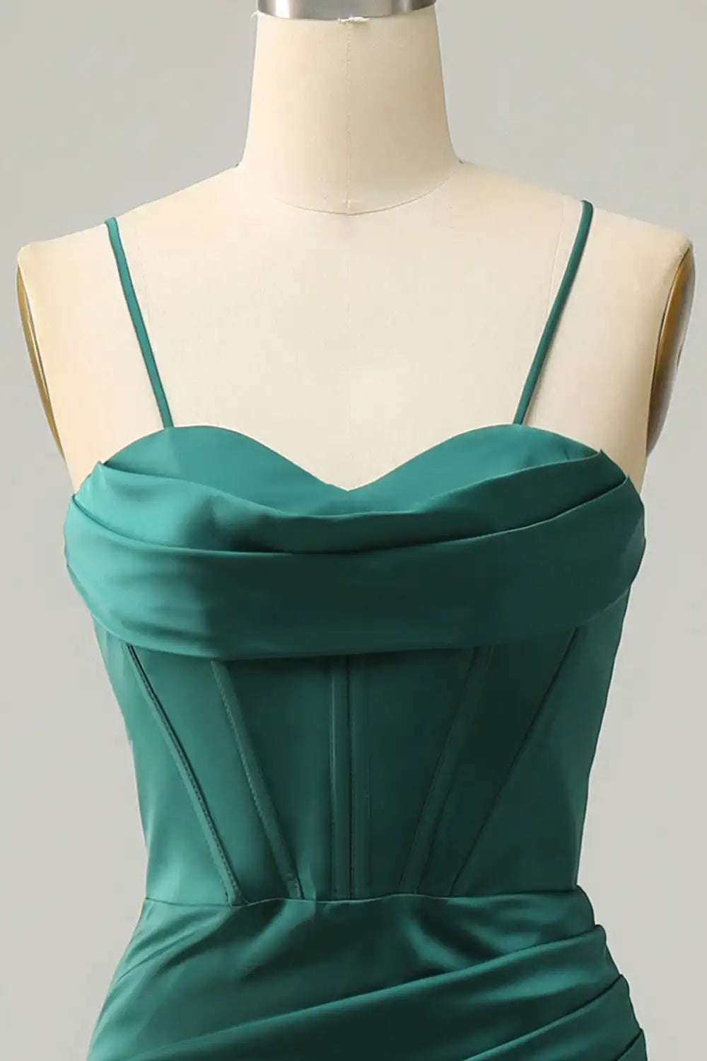 Green dress on a mannequin against a gray background