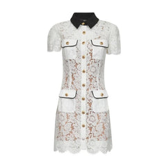 White lace dress with black collar and gold buttons on a white background