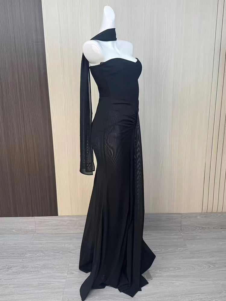 Black evening gown on a mannequin against a neutral background