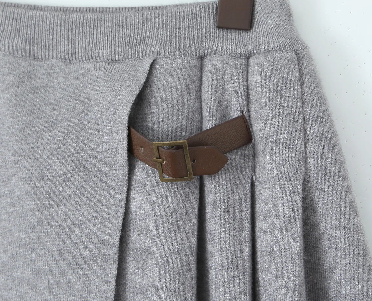Gray sweater with a brown leather belt and buckle on a white background