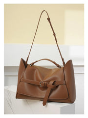 Brown leather handbag on a light background