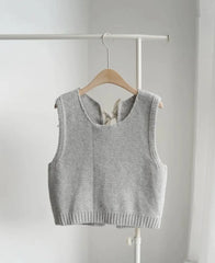 Gray knitted vest on a hanger against a white background