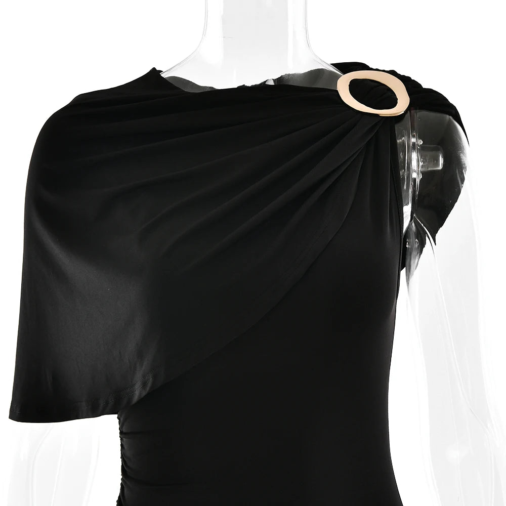 Black draped garment on a mannequin with a beige circular accent against a white background