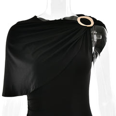 Black draped garment on a mannequin with a beige circular accent against a white background