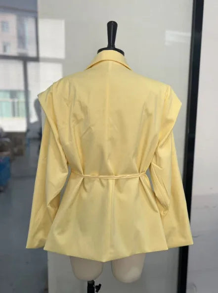 Yellow jacket on a mannequin against a neutral background