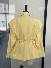 Yellow jacket on a mannequin against a neutral background