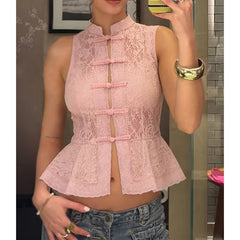 Person wearing a pink lace top with a peplum waist.