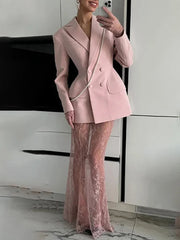 Person wearing a pink suit with a sheer pink skirt in an indoor setting.