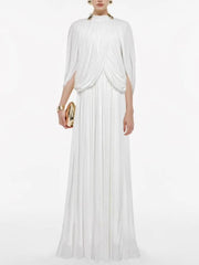 Woman wearing a white flowing dress on a white background
