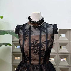 Close-up of black lace stand collar mini dress neckline