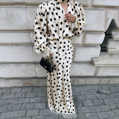 Close-up of a polka dot satin puff sleeve blouse and maxi skirt set