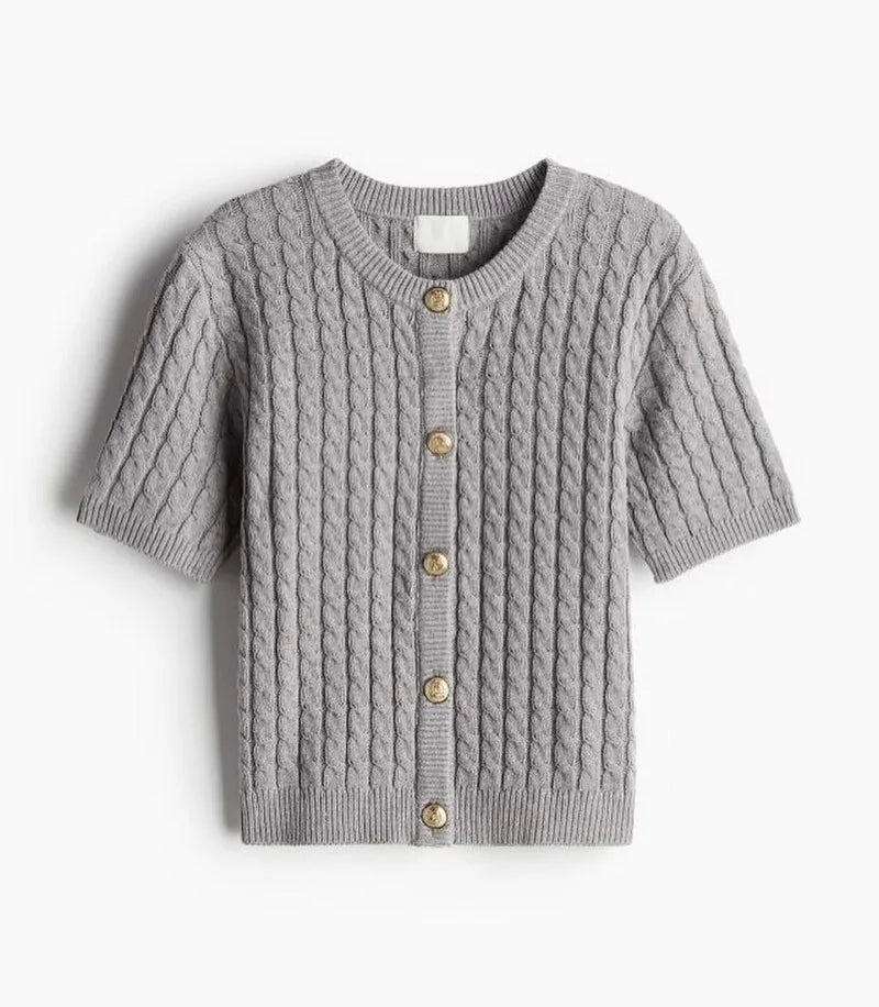 Gray cable knit cardigan with button details on a white background