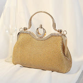 Gold crystal-encrusted clutch bag with ring handle