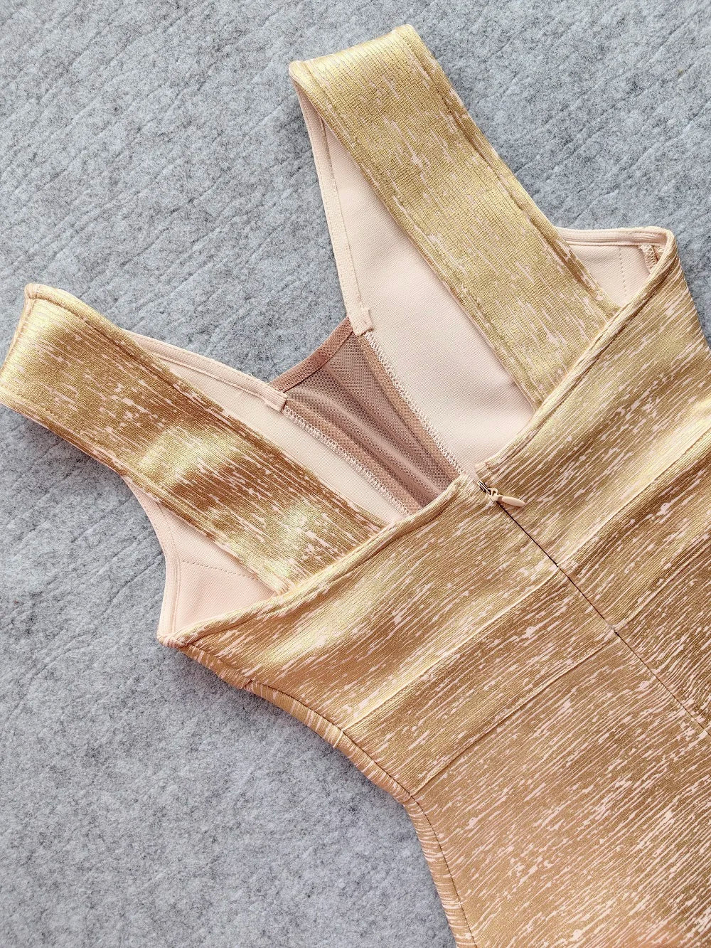 Gold metallic top on a gray surface