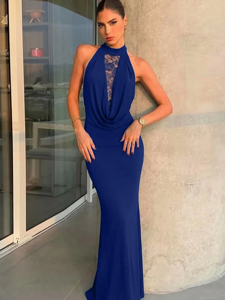 Woman wearing a blue evening gown with a lace neckline in an indoor setting.