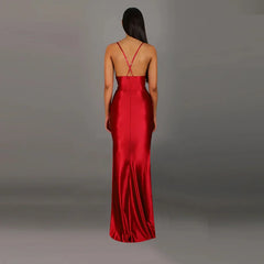 Red evening gown with a backless design on a gray background