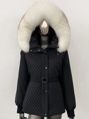 Black quilted parka with a large fur hood on a mannequin against a white background