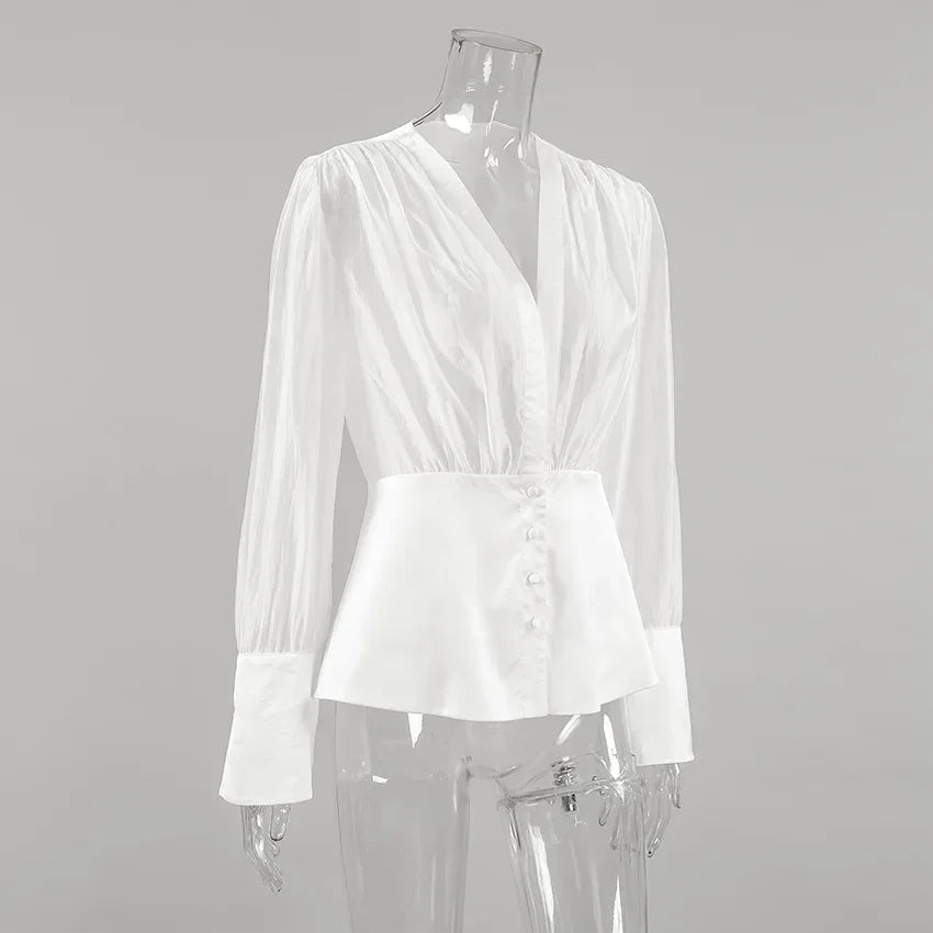 White blouse on a mannequin against a gray background
