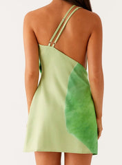 Green dress with a leaf design on a plain background