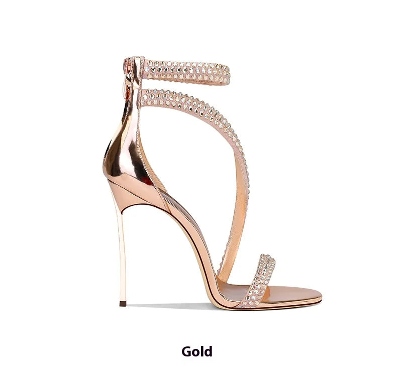 Gold high-heeled sandal with crystal embellishments on a white background