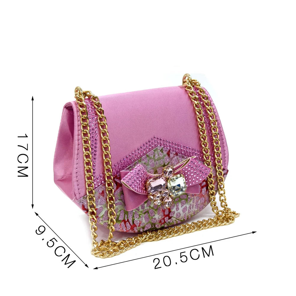 Pink handbag with gold chain and measurements on a white background