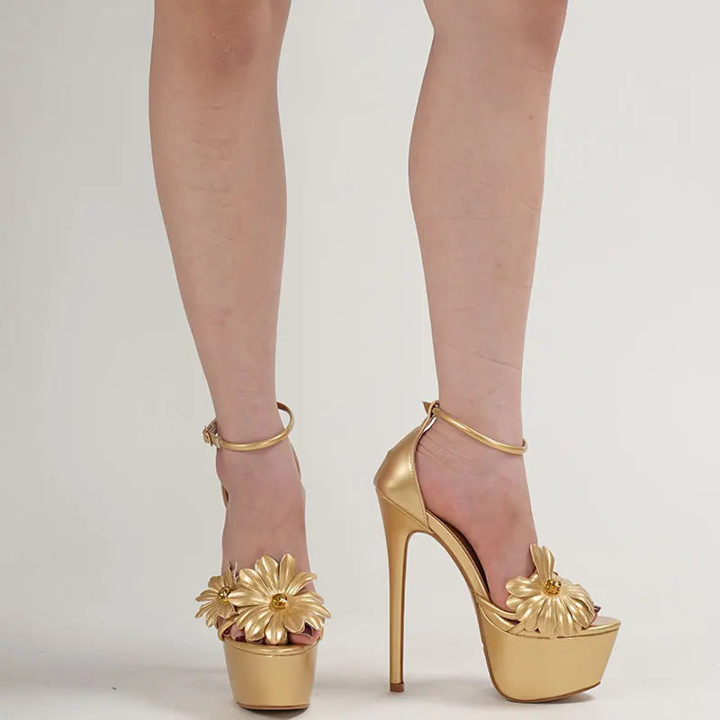 Gold high-heeled shoes with floral designs