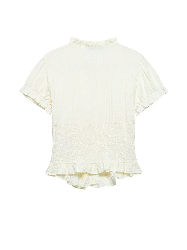 White blouse with ruffled details on a white background