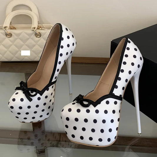 White polka dot platform pumps with black trim and bow