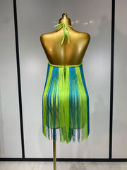 Close-up on fringe detail of lime green and blue halter mini dress