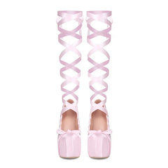 Pink over-the-knee shoes with ribbon design on a white background