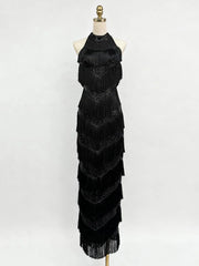 Black fringe dress on a mannequin against a white background