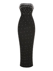 Black strapless dress with white bead embellishments on a white background