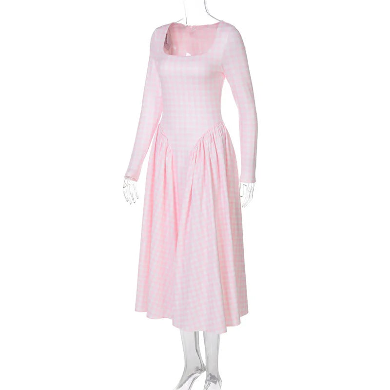 Pink dress on a mannequin against a white background