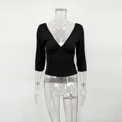 Black V-neck top on a transparent mannequin against a white background