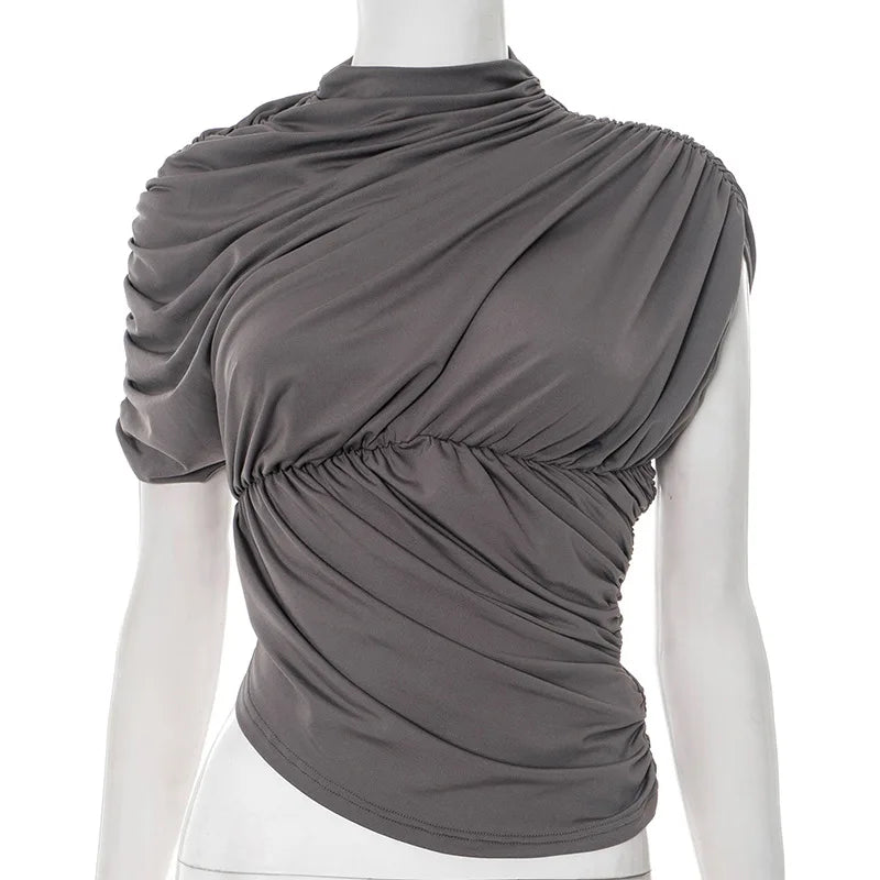 Gray draped top on a mannequin against a white background