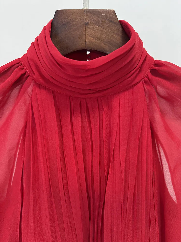 Close-up of red chiffon high neck dress detail