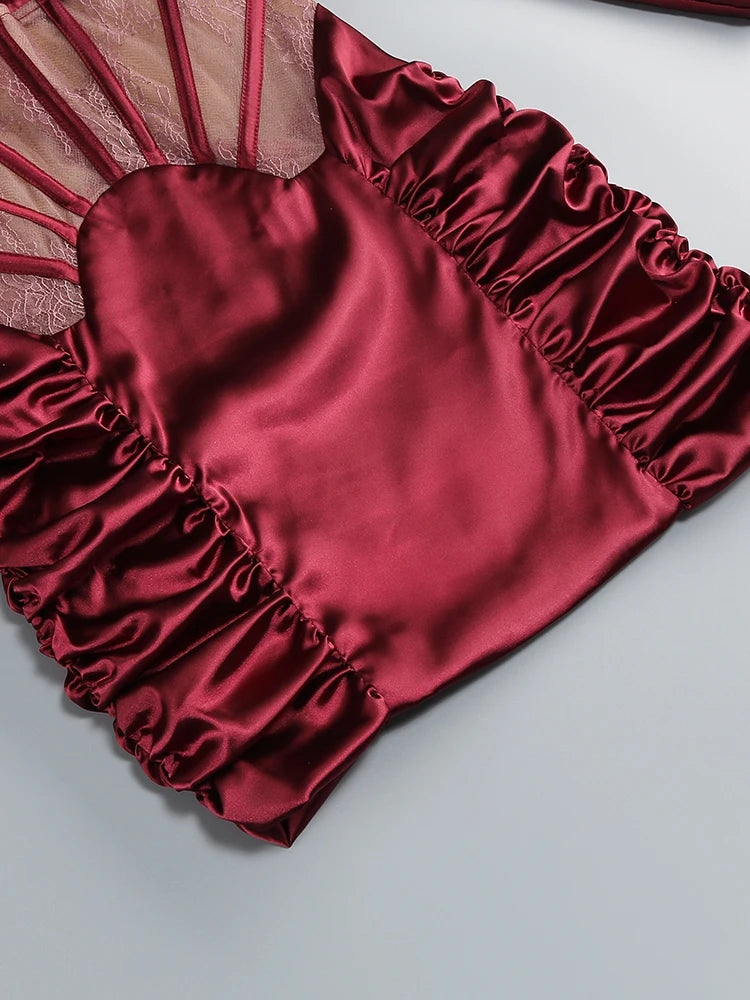Red satin garment with ruffled details on a light gray background