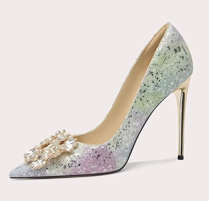 High-heeled shoe with glittery design and decorative element on a light gray background