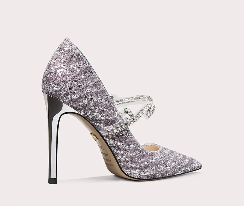 Silver glitter high-heeled shoe on a light gray background