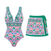 One-piece swimsuit and wrap skirt beachwear set with a vibrant graphic print.